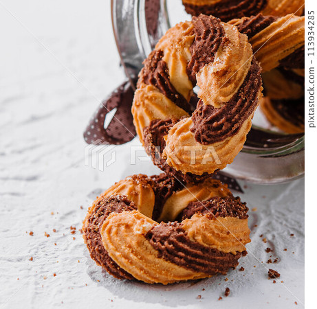 Chocolate cookies in a glass jar opened 113934285