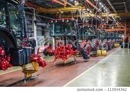 Tractor industry manufacture. New tractors on factory line. Production of agricultural machinery 113934362