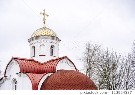Russian Christian Orthodox church with domes and a cross against the sky. Russian Orthodoxy and Christian Faith concept.  113934587