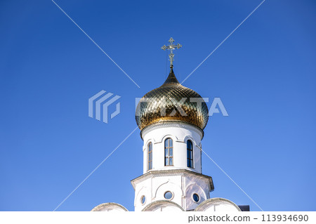 Russian Christian Orthodox church with domes and a cross against the sky. Russian Orthodoxy and Christian Faith concept.  113934690