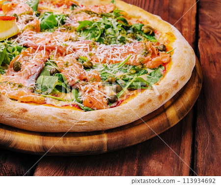 Italian Pizza with salmon, arugula and capers 113934692