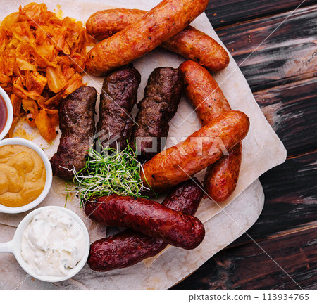Beer set of grilled sausages with stewed cabbage and sauces Beer set of grilled sausages with stewed cabbage and sauces 113934765