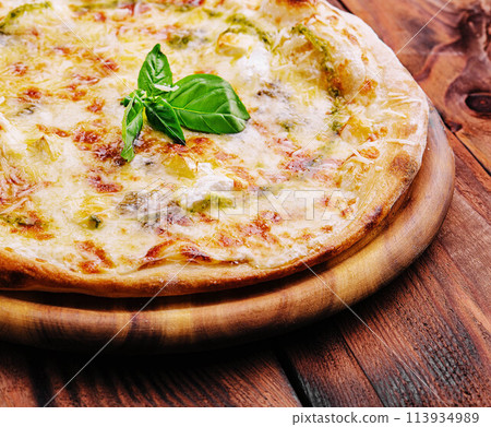 Tasty pizza with pesto sauce on wooden background Tasty pizza with pesto sauce on wooden background 113934989