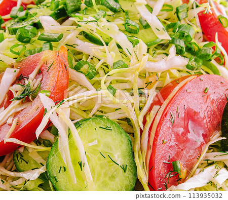 Salad from fresh cabbage, cucumbers and tomatoes 113935032