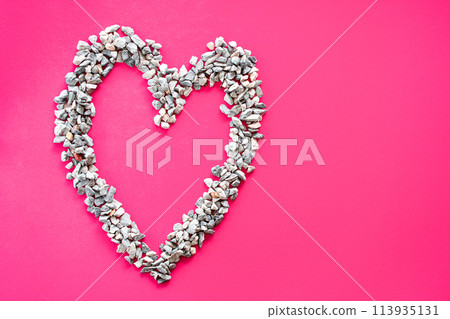 Heart symbol Made of small stones Or pebbles placed on a pink background. It is a concept of love day or Valentine's day. Take a top view and close-up Heart symbol Made of small stones Or pebbles placed on a pink background. It is a concept of love day or Valentine's day. Take a top view and close-up 113935131