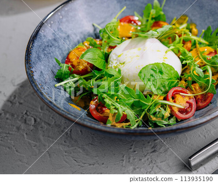Delicious burrata salad top view Delicious burrata salad top view 113935190