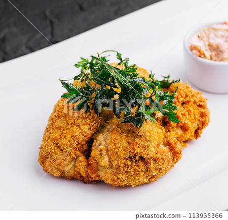 Chicken schnitzel with sauce on plate 113935366