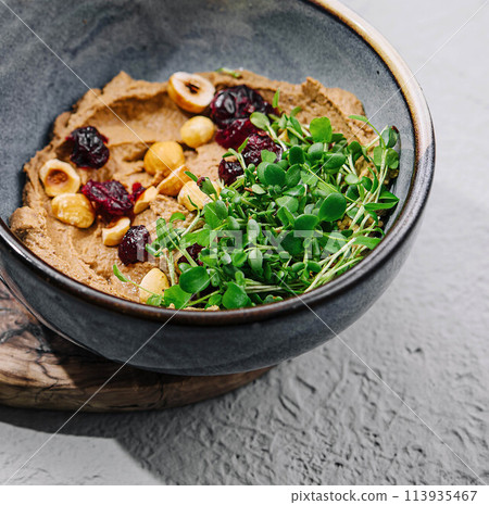 Bowl of hummus with chickpeas close up 113935467