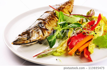 Baked mackerel with steamed vegetables on plate Baked mackerel with steamed vegetables on plate 113935473