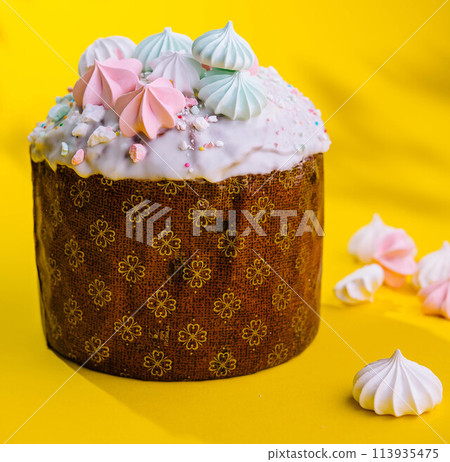 Traditional Easter cakes with meringue on yellow background Traditional Easter cakes with meringue on yellow background 113935475