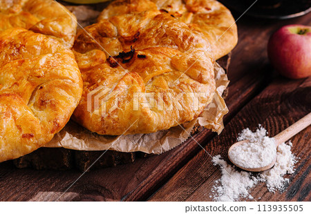 Cooking traditional pies with apple and pumpkin on wooden board Cooking traditional pies with apple and pumpkin on wooden board 113935505