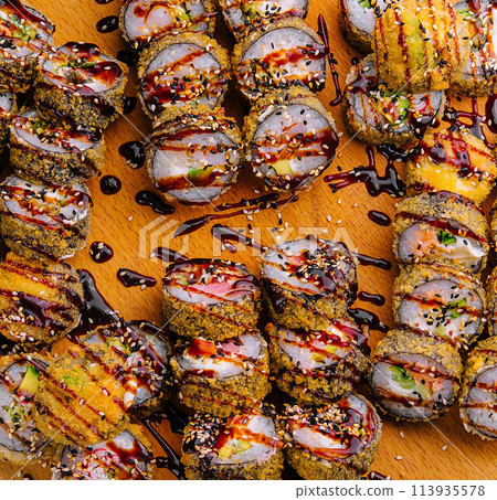 warm tempura sushi roll on wood top view warm tempura sushi roll on wood top view 113935578