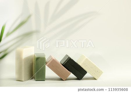 Natural handmade soaps on light green background 113935608