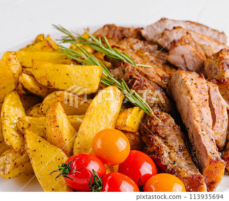 Grilled kebab pork meat with roasted potato and vegetables 113935694