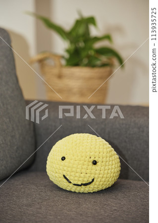 Cute soft knitted toy on the sofa Cute soft knitted toy on the sofa 113935725