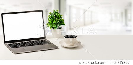 The Concept for business, technology, internet, design, programmer. .Blank white screen laptop, coffee cup, and vase are placed on a white desk in office. Close up, selective focus, blurred background 113935892