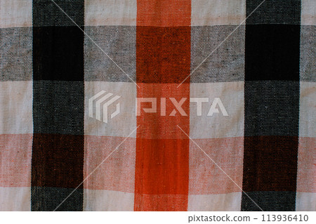 The men's tartan is a beautiful and colorful art in Malaysia, Indonesia, and Thailand. Fabric for men in Asia Wear it in the shower or wear it while relaxing. Close-up photo with horizontal background The men's tartan is a beautiful and colorful art in Malaysia, Indonesia, and Thailand. Fabric for men in Asia Wear it in the shower or wear it while relaxing. Close-up photo with horizontal background 113936410