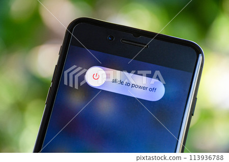 A phone with a slider to power off button on the screen A phone with a slider to power off button on the screen 113936788