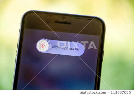 A phone with a slide to power off button on the screen 113937090