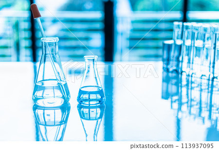 Two beakers of water sit on a table Two beakers of water sit on a table 113937095