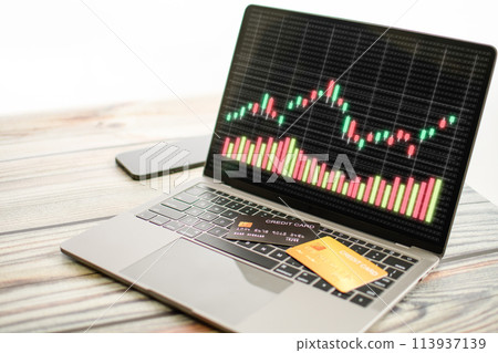 A laptop computer is open to a screen displaying a graph of stock prices A laptop computer is open to a screen displaying a graph of stock prices 113937139