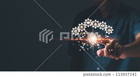 A man is pointing at a screen with a picture of gears and a light bulb A man is pointing at a screen with a picture of gears and a light bulb 113937141
