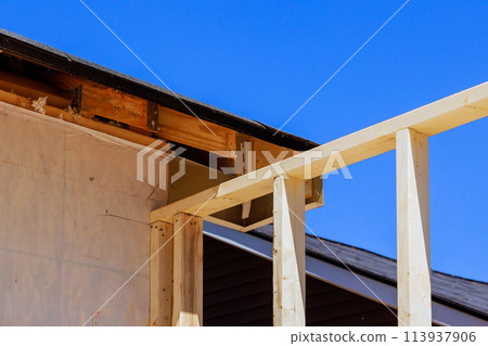 During new construction home improvement unfinished framing beams wooden house an building area During new construction home improvement unfinished framing beams wooden house an building area 113937906