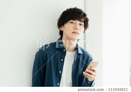 A young man with a smartphone 113938921