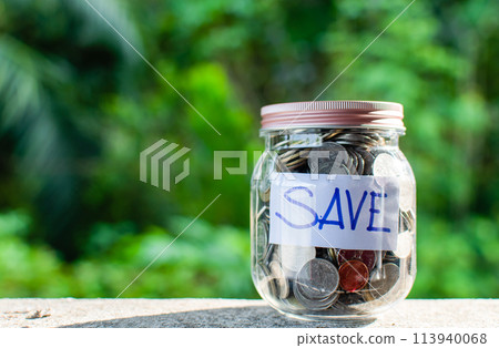 A jar full of coins with the word save written on it A jar full of coins with the word save written on it 113940068