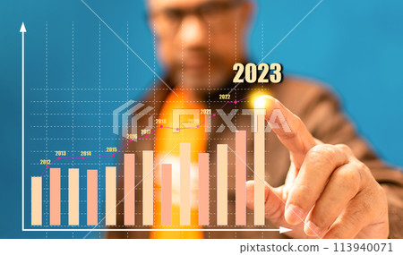 A man is pointing at a graph with the year 2013 on it A man is pointing at a graph with the year 2013 on it 113940071