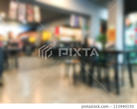 A blurry image of a restaurant with tables and chairs 113940150
