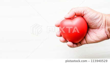 A hand holding a red heart A hand holding a red heart 113940529