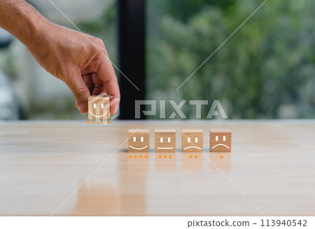 A hand is holding a smiley face block 113940542