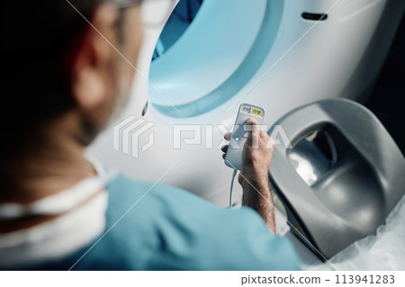 High angle view shot of unrecognizable doctor adjusting MRI scanner settings for next patient, copy space 113941283