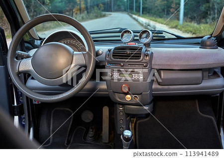 Shift lever, car steering wheel and sensors. Inside a modern car view, city car interior background 113941489