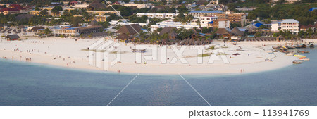 Aerial view of Kendwa beach with a lot of people and a boat in the water 113941769