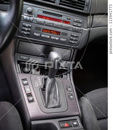 Shift lever, car steering wheel and sensors. Inside a modern car view, city car interior background 113941773