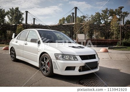 White car on a street background. Modern city sport car with a spoiler wallpaper White car on a street background. Modern city sport car with a spoiler wallpaper 113941920