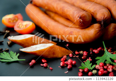 Tasty sausages and vegetables isolated over solid background 113942220