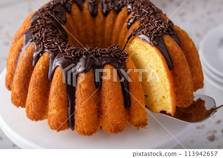 Orange pound cake with dark chocolate ganache and sprinkles Orange pound cake with dark chocolate ganache and sprinkles 113942657