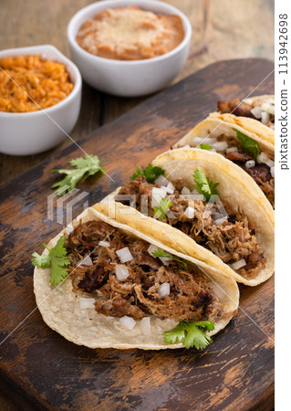 Pork carnitas tacos on a cutting board Pork carnitas tacos on a cutting board 113942698