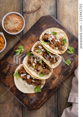 Pork carnitas tacos on a cutting board 113942703