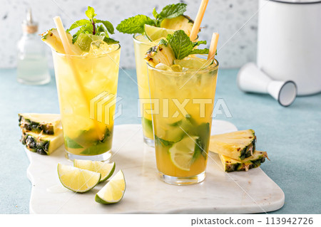 Pineapple mojito with limes and mint and a slice of pineapple 113942726
