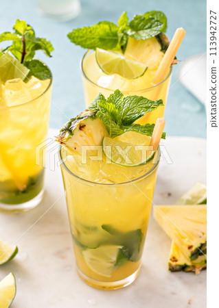 Pineapple mojito with limes and mint and a slice of pineapple 113942727