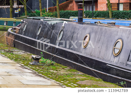 Castlefiled neighborhood canals with moored narrowboats on the waterfront in Manchester, UK. Castlefiled neighborhood canals with moored narrowboats on the waterfront in Manchester, UK. 113942789