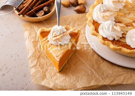 Pumpkin pie with cheesecake swirl, dessert variation for Thanksgiving 113943149