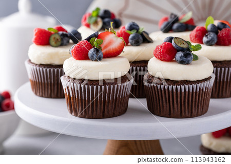 Chocolate cupcakes with cream cheese frosting and fresh berries Chocolate cupcakes with cream cheese frosting and fresh berries 113943162
