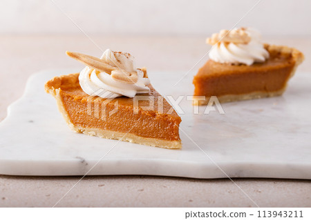 Traditional pumpkin pie for Thanksgiving with whipped cream 113943211