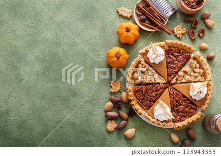Traditional Thanksgiving pies cut into slices with pumpkin, pecan and crumble Traditional Thanksgiving pies cut into slices with pumpkin, pecan and crumble 113943333