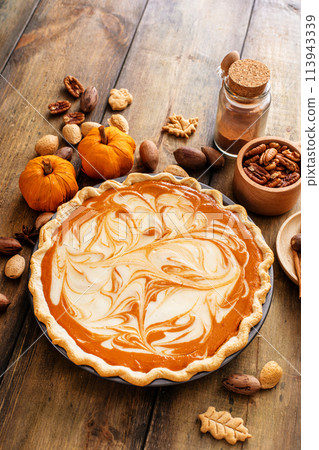 Pumpkin pie with cheesecake swirl, dessert variation for Thanksgiving 113943339
